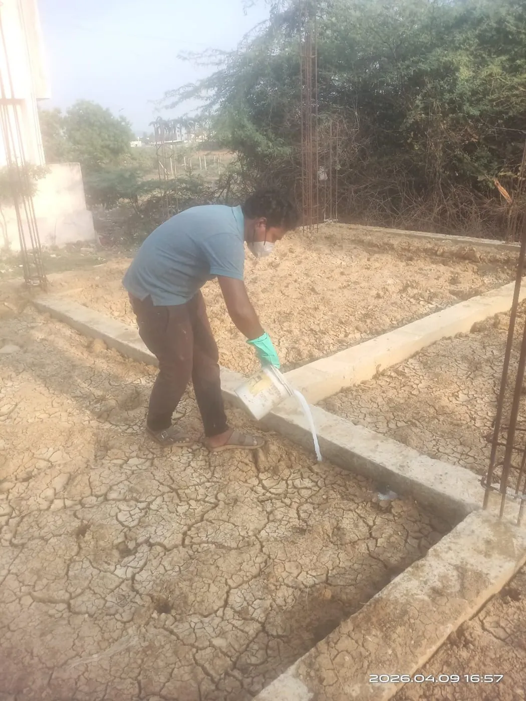 Pre-construction anti-termite soil treatment in a foundation trench